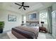 Comfortable main bedroom features a plush bed, ceiling fan, and natural lighting at 603 Fortuna Dr, Davenport, FL 33837