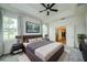 A main bedroom with a large bed, a television, and a door to a walk-in closet at 603 Fortuna Dr, Davenport, FL 33837
