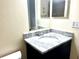 Bathroom featuring a marble vanity top with a sink and a framed mirror above at 6042 Amberly Ave # F55, Orlando, FL 32822