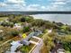 Aerial view of a home in a lush, green neighborhood close to a serene lake at 605 Hill Ave, Ocoee, FL 34761