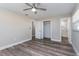 Neutral bedroom with a ceiling fan, closet, and en-suite bathroom featuring a tiled shower at 605 Hill Ave, Ocoee, FL 34761