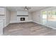 Living room with a fireplace and sliding glass door to the back patio at 605 Hill Ave, Ocoee, FL 34761