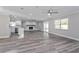 Open floor plan with a fireplace, sliding glass door to the back patio, and kitchen at 605 Hill Ave, Ocoee, FL 34761