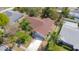 Aerial view of a home with a brown roof surrounded by trees at 6385 Royal Tern St, Orlando, FL 32810