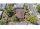 Aerial view of a single-Gathering home with a brown roof and landscaping at 6385 Royal Tern St, Orlando, FL 32810