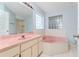 Bright bathroom featuring a pink tub, sink, and modern fixtures at 6385 Royal Tern St, Orlando, FL 32810