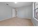 Cozy bedroom with neutral walls, carpet flooring, and natural light from the window at 6385 Royal Tern St, Orlando, FL 32810