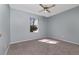 Bedroom with carpet flooring, ceiling fan and natural light from the window at 6385 Royal Tern St, Orlando, FL 32810