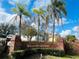 Willow Creek community entrance with brick sign, palm trees, and lush landscaping at 6385 Royal Tern St, Orlando, FL 32810