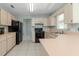 Functional kitchen featuring light wood cabinets, black appliances, and ample counter space, ideal for cooking and storage at 6385 Royal Tern St, Orlando, FL 32810