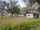 Spacious backyard with mature trees, a shed, and plenty of room for outdoor activities at 701 S Delaware Ave, Deland, FL 32720