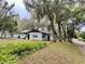 Lush backyard featuring mature trees, including picturesque Spanish moss, enhancing the natural appeal at 701 S Delaware Ave, Deland, FL 32720