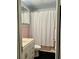 Bathroom featuring vintage pink tile and a white shower curtain at 701 S Delaware Ave, Deland, FL 32720