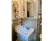 Modest but functional bathroom with efficient shelving and vanity at 701 S Delaware Ave, Deland, FL 32720