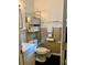 Well-lit bathroom featuring a tiled wall and convenient wall storage at 701 S Delaware Ave, Deland, FL 32720