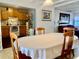 Inviting dining area with a large table, wooden chairs, and a view into the living room at 701 S Delaware Ave, Deland, FL 32720