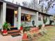 Charming single-story home featuring a covered porch, lovely landscaping, and an inviting entrance at 701 S Delaware Ave, Deland, FL 32720