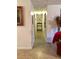 Bright hallway with neutral walls, decorative accents, and access to multiple rooms at 701 S Delaware Ave, Deland, FL 32720