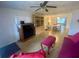 Open-concept living room and dining area with vintage hutch and natural light at 701 S Delaware Ave, Deland, FL 32720