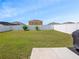 Expansive backyard enclosed by a white fence with a lush green lawn at 756 Kindred Ln, Auburndale, FL 33823