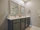 Bathroom featuring double sinks, neutral paint, framed mirrors, and a sleek vanity for a modern aesthetic at 756 Kindred Ln, Auburndale, FL 33823