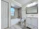 Clean bathroom featuring a tiled shower, modern vanity, arched window, and stylish fixtures at 8438 Diamond Cove Cir, Orlando, FL 32836