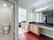 Bathroom featuring vanity, toilet, and a doorway to the shower at 8438 Diamond Cove Cir, Orlando, FL 32836