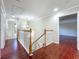 Bright hallway featuring hardwood floors, staircase, and an overhead light fixture at 8438 Diamond Cove Cir, Orlando, FL 32836