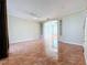 Expansive living room featuring tile flooring, a ceiling fan, and built-in shelving at 8438 Diamond Cove Cir, Orlando, FL 32836