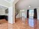 Bright living room featuring tile floors, large windows, and an open layout to the kitchen and staircase at 8438 Diamond Cove Cir, Orlando, FL 32836