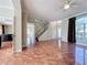 Bright open-concept living room featuring tiled floors, staircase, and large windows at 8438 Diamond Cove Cir, Orlando, FL 32836