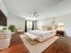 Spacious main bedroom featuring hardwood floors, a ceiling fan, and neutral decor at 8438 Diamond Cove Cir, Orlando, FL 32836