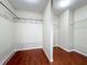 Spacious walk-in closet featuring hardwood floors and storage shelves at 8438 Diamond Cove Cir, Orlando, FL 32836