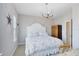 A bright bedroom featuring an antler chandelier, a bed with patterned bedding, and an ensuite bathroom at 8803 Peachtree Park Ct, Windermere, FL 34786