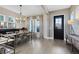 Bright dining room with light wood flooring, modern chandelier, and lots of natural light at 8803 Peachtree Park Ct, Windermere, FL 34786