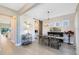 Open-concept dining room featuring a modern chandelier, light wood floors, and a glimpse of the kitchen at 8803 Peachtree Park Ct, Windermere, FL 34786