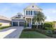 Charming two-story home with a two-car garage, brick-paved driveway, and lush landscaping at 8803 Peachtree Park Ct, Windermere, FL 34786