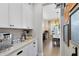 Kitchen nook includes built-in storage, a marble backsplash, and high-end appliances for coffee and beverages at 8803 Peachtree Park Ct, Windermere, FL 34786