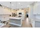 Bright kitchen boasts an island, stainless appliances, pendant lighting, and modern white cabinetry at 8803 Peachtree Park Ct, Windermere, FL 34786