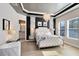 This main bedroom features a tufted headboard, chandelier, and ensuite bathroom at 8803 Peachtree Park Ct, Windermere, FL 34786