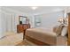 Comfortable bedroom with soft tan bedding, wood furniture, and neutral carpet at 921 Emerald Green Ct, Kissimmee, FL 34746