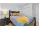 Bedroom featuring a bed with gray bedding and yellow accents and a dark wood nightstand at 921 Emerald Green Ct, Kissimmee, FL 34746