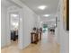 Inviting hallway with neutral tile flooring leading to a bedroom and open-concept living area at 921 Emerald Green Ct, Kissimmee, FL 34746