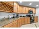 Spacious kitchen featuring granite countertops, wood cabinets and stainless steel appliances at 921 Emerald Green Ct, Kissimmee, FL 34746