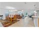 Bright and spacious living room with dining area featuring tile floors and sliding glass doors at 921 Emerald Green Ct, Kissimmee, FL 34746