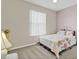 Cozy bedroom with a floral-themed bedspread, carpeted floors, and natural light at 10286 Cypress Knee Cir, Orlando, FL 32825