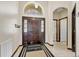 Welcoming foyer featuring a large arch window above the stylish front door and neutral tile flooring at 10286 Cypress Knee Cir, Orlando, FL 32825