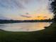 Scenic lake view at sunset with vibrant colors reflecting on the water's surface at 10286 Cypress Knee Cir, Orlando, FL 32825