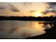 Beautiful sunset over the lake, casting warm light on the water and the distant shoreline at 10286 Cypress Knee Cir, Orlando, FL 32825