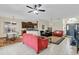 Bright and airy living room featuring neutral tile flooring seamlessly connecting to the kitchen and foyer at 10286 Cypress Knee Cir, Orlando, FL 32825